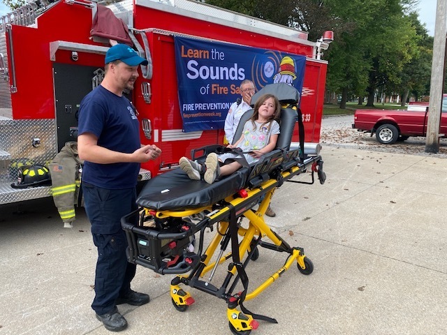 EMT Gerkin talked about 911 services and the kids tried out some of their equipment.
