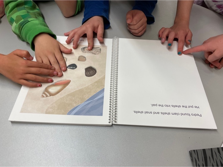 Feeling the letters and pictures in a Braille book  